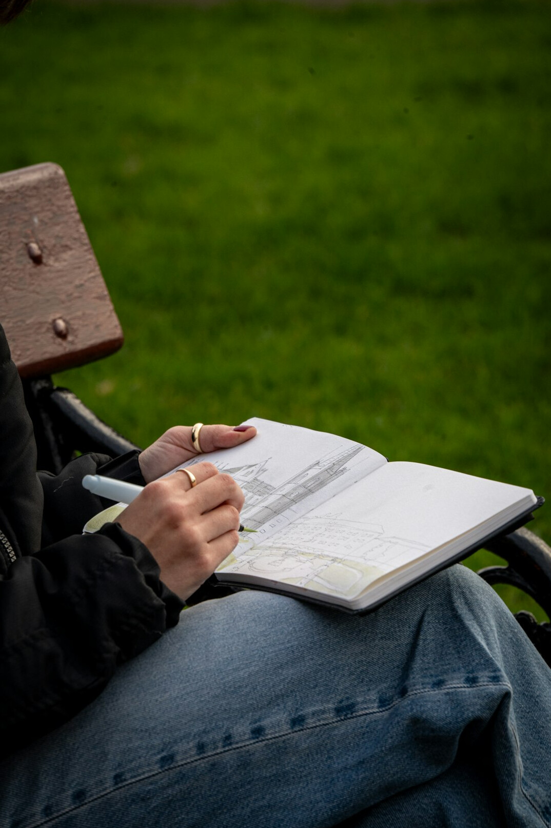 woman writing in journal outdoors